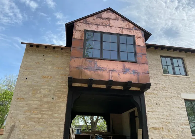 Copper metal panel facade on a stone building for Metal Roof Coating in Bixby
