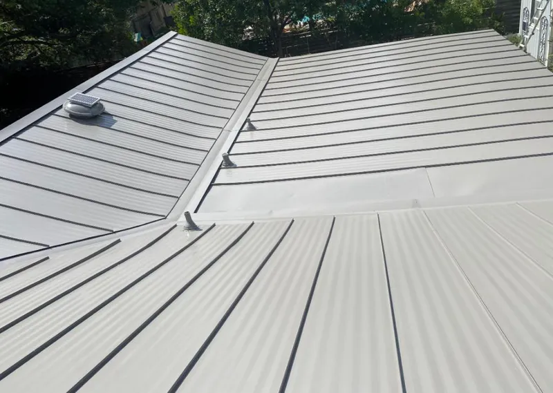 Solar attic fan installed on a metal roof for Roof Ventilation in Bixby